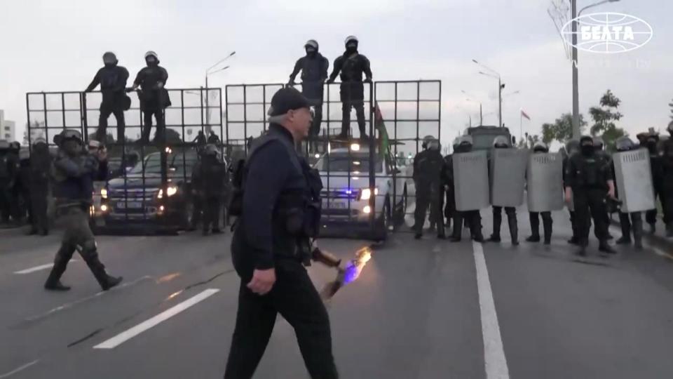 This grab taken from a video released by Belarus state agency "Belta" shows President Alexander Lukashenko holding an automatic rifle and wearing body armour as he arrives, on August 23, 2020, at his residence in Minsk, not far from where opposition protests are taking place. - Tens of thousands of demonstrators massed in central Minsk on Sunday to demand the resignation of Belarusian President Alexander Lukashenko, who flew over the scene of the banned protest in a helicopter and called the marchers "rats". (Photo by - / BELTA / AFP) / RESTRICTED TO EDITORIAL USE - MANDATORY CREDIT "AFP PHOTO / BELTA " - NO MARKETING - NO ADVERTISING CAMPAIGNS - DISTRIBUTED AS A SERVICE TO CLIENTS (Photo by -/BELTA/AFP via Getty Images) ORIG FILE ID: AFP_1WP433