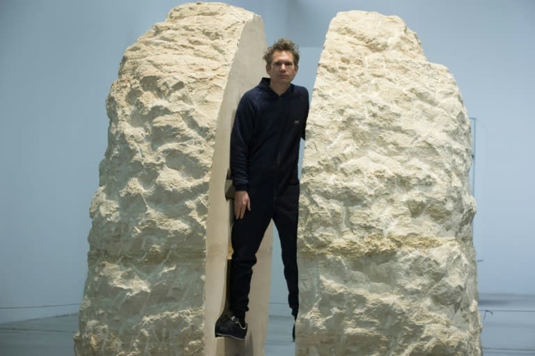 Artist Abraham Poincheval has hollowed out a hole in the rock just big enough for him to sit