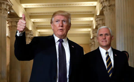 U.S. President Donald Trump gives a thumbs-up as he and Vice President Mike Pence depart the U.S. Capitol after a meeting to discuss tax legislation with House Republicans in Washington, U.S., November 16, 2017. REUTERS/Kevin Lamarque