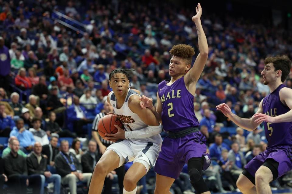 Jaiden Dixon of Frederick Douglass drives against Demetris White of Male.