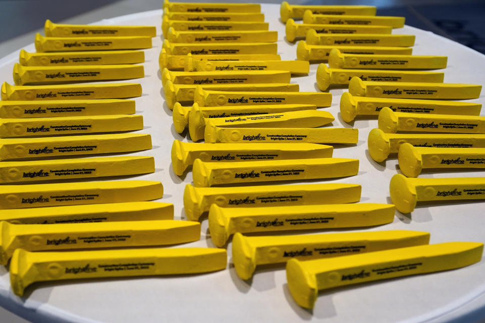 Souvenir gold railroad spikes to celebrate the completion of the construction of the Brightline high speed rail were given to VIP's and Brightline employees on Wednesday, June 21, 2023, in Orlando, Fla. The rail system now connects Miami to Orlando. (AP Photo/John Raoux)