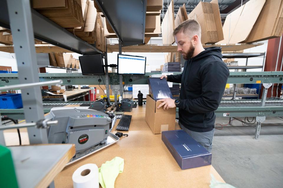 Warehouse manager Kyle Andrew boxes up Boroux foundation filters at the James Enterprise Inc. facility on Wednesday, January 17, 2024.