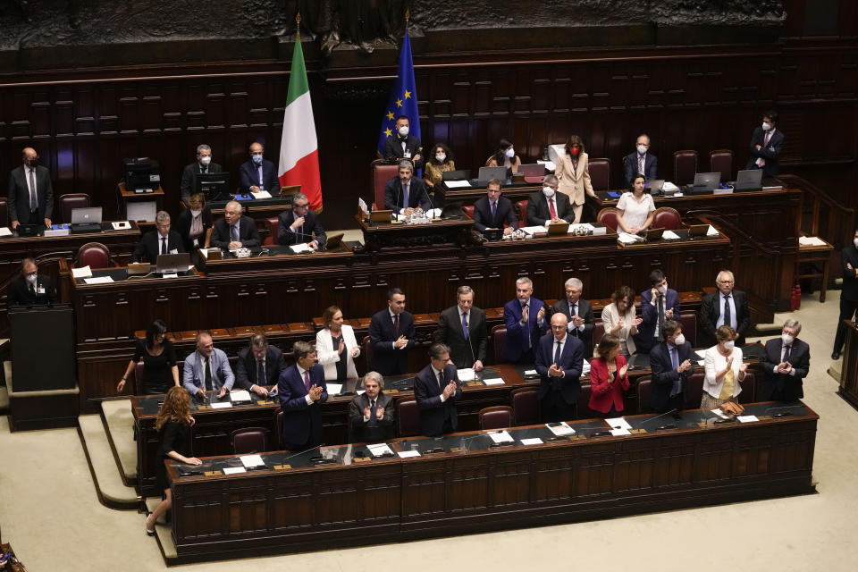 Italian Premier Mario Draghi, background center, delivers his speech at the Parliament in Rome, Thursday, July 21, 2022. Italian Premier Mario Draghi has won a confidence vote in the Senate, but boycotts by three of his key coalition allies in the voting seem likely to have doomed the government's prospects of survival. (AP Photo/Andrew Medichini)