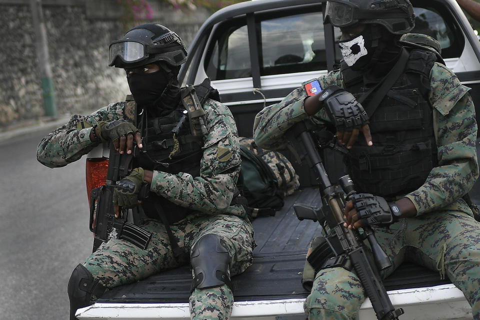 Soldiers stand guard near the residence of Interim President Claude Joseph in Port-au-Prince, Haiti, Sunday, July 11, 2021, four days after the assassination of Haitian President Jovenel Moise. (AP Photo/Matias Delacroix)