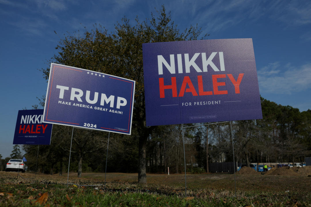 Campaign signs for Republican presidential candidates stand along a road in South Carolina.