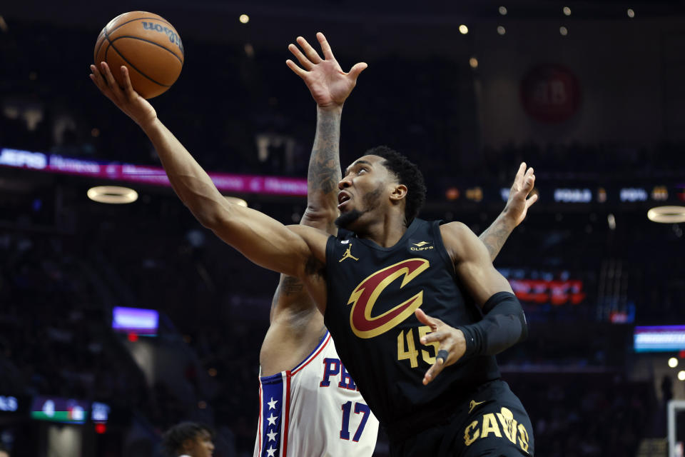 Cleveland Cavaliers guard Donovan Mitchell (45) shoots against Philadelphia 76ers forward P.J. Tucker (17) during the first half of an NBA basketball game, Wednesday, March 15, 2023, in Cleveland. (AP Photo/Ron Schwane)