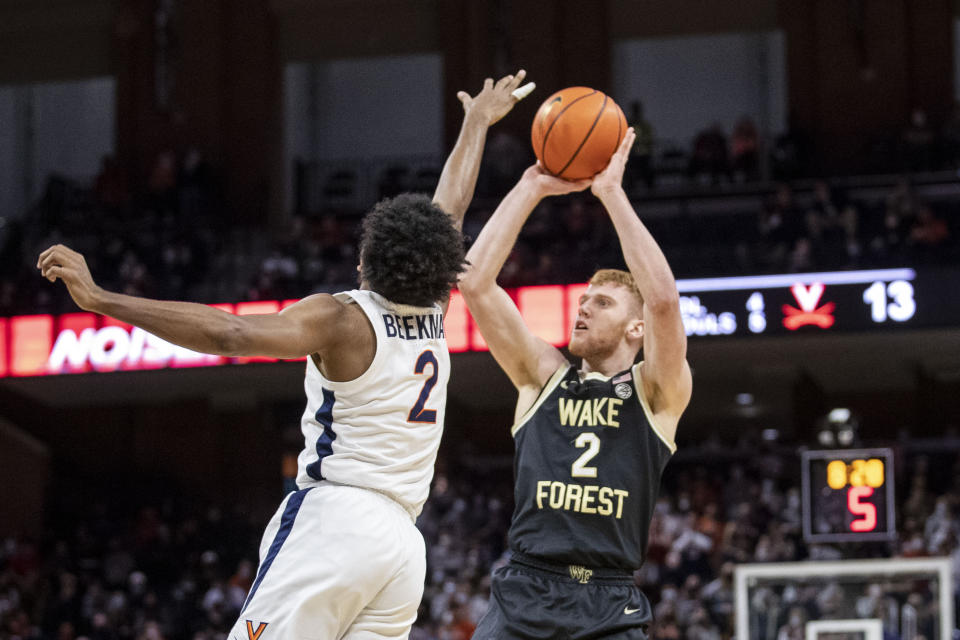 Virginia guard Reece Beekman (2) defends as Wake Forest guard Cameron Hildreth (2) shoots during the first half of an NCAA college basketball game in Charlottesville, Va., Saturday, Jan. 15, 2022. (AP Photo/Erin Edgerton)