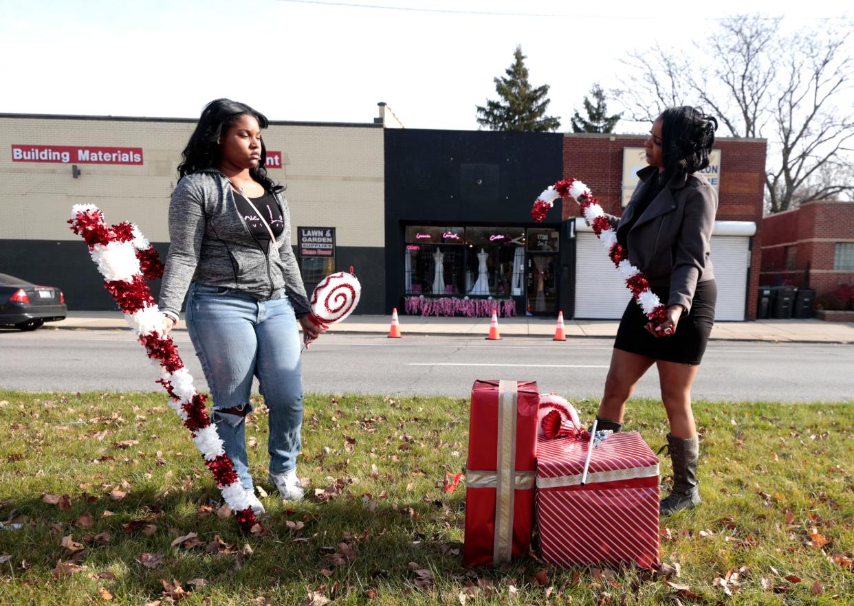 (L to R) Alexandria Evans, 16 and her mother Lola Black, 46, talk while adding Christmas ornaments on the median outside of her store, Lucania Lavish Couture in Detroit on Thursday, November 16, 2023.