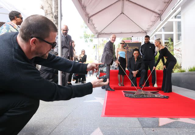 <p>Rodin Eckenroth/Getty </p> Channing Tatum snaps a photo of Lenny and Zoe Kravitz during the ceremony