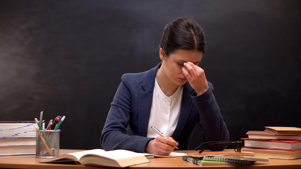 A professor becomes stressed out while working in her classroom