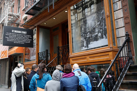 People stand outside the New York's Tenement Museum as part of a tour in New York U.S., November 21, 2016. REUTERS/Shannon Stapleton