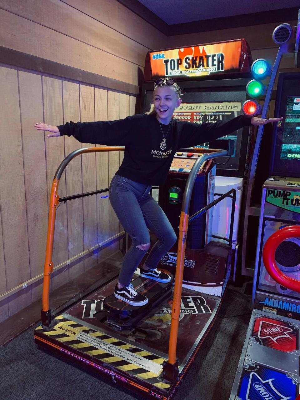 Gabby Petito plays a skateboarding video game at an arcade. (Find Gabby Facebook page)