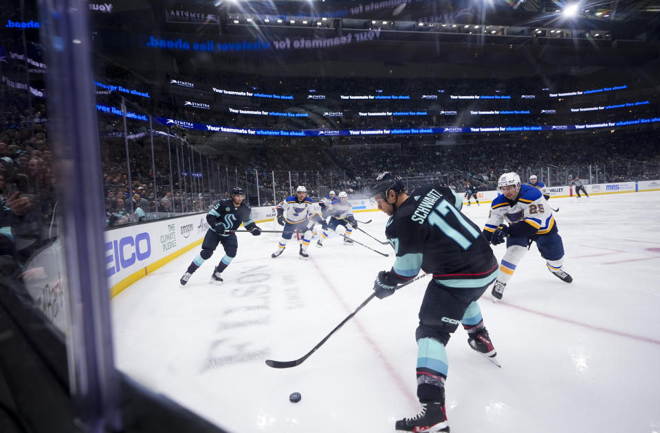 Seattle Kraken center Jaden Schwartz (17) looks to pass the puck as St. Louis Blues center Jordan Kyrou (25) approaches during the first period of an NHL hockey game Friday, Jan. 26, 2024, in Seattle. (AP Photo/Lindsey Wasson)