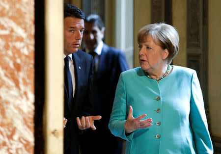 Italian Prime Minister Matteo Renzi (L) talks with German Chancellor Angela Merkel as they arrive for a news conference at Chigi Palace in Rome, Italy May 5, 2016. REUTERS/Max Rossi
