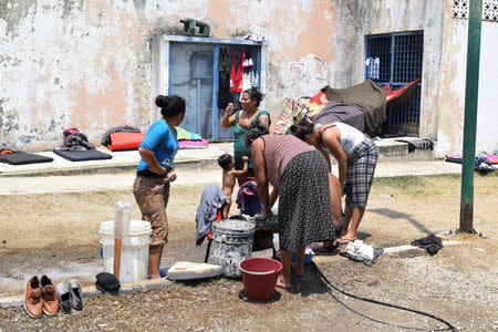 Migrants from Central America wash their clothes at a improvised shelter while waiting for their humanitarian visas to cross the country on their way to the United States, in Mapastepec, in Chiapas state, Mexico April 3, 2019. REUTERS/Jose Torres