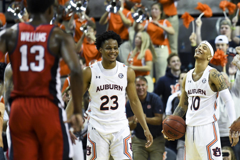 Auburn forward Isaac Okoro (23) and guard Samir Doughty (10) celebrate the final rebound against Mississippi in an NCAA college basketball game Tuesday, Feb. 25, 2020, in Auburn, Ala. (AP Photo/Julie Bennett)