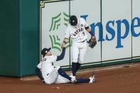 Oct 21, 2017; Houston, TX, USA; Houston Astros center fielder George Springer (4) is helped up by left fielder Marwin Gonzalez (9) during the seventh inning in game seven of the 2017 ALCS playoff baseball series against the New York Yankees at Minute Maid Park. Troy Taormina-USA TODAY Sports