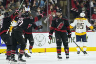 Carolina Hurricanes center Jordan Staal, front right, celebrates his goal against the Nashville Predators with defenseman Brett Pesce (22) during the third period in Game 1 of an NHL hockey Stanley Cup first-round playoff series in Raleigh, N.C., Monday, May 17, 2021. (AP Photo/Gerry Broome)