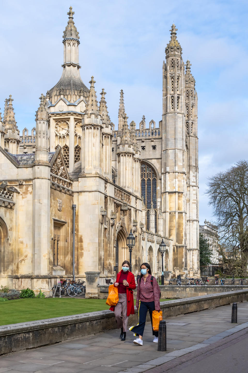 Two girls walk past King's College in an eerily quiet Cambridge.