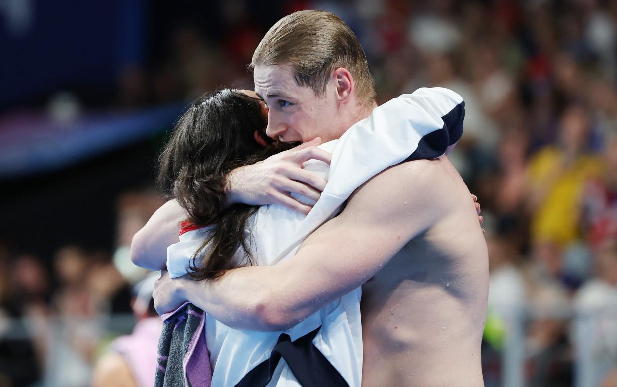 Close friends Alice Tai and Stephen Clegg embrace after Clegg's victory in the men's 100m butterfly