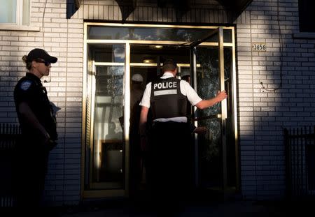 Police investigators walk into the residence of Amor Ftouhi, in Montreal, Quebec, Canada, June 21, 2017. Ftouhi has been identified as a suspect by the FBI in the stabbing of a police officer inside the main terminal of a small airport in Flint, Michigan. REUTERS/Christinne Muschi