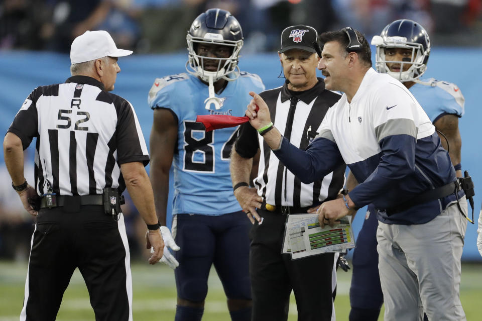 Tennessee Titans head coach Mike Vrabel, right argues about the placement of the ball late in the fourth quarter of an NFL football game against the Los Angeles Chargers Sunday, Oct. 20, 2019, in Nashville, Tenn. (AP Photo/James Kenney)