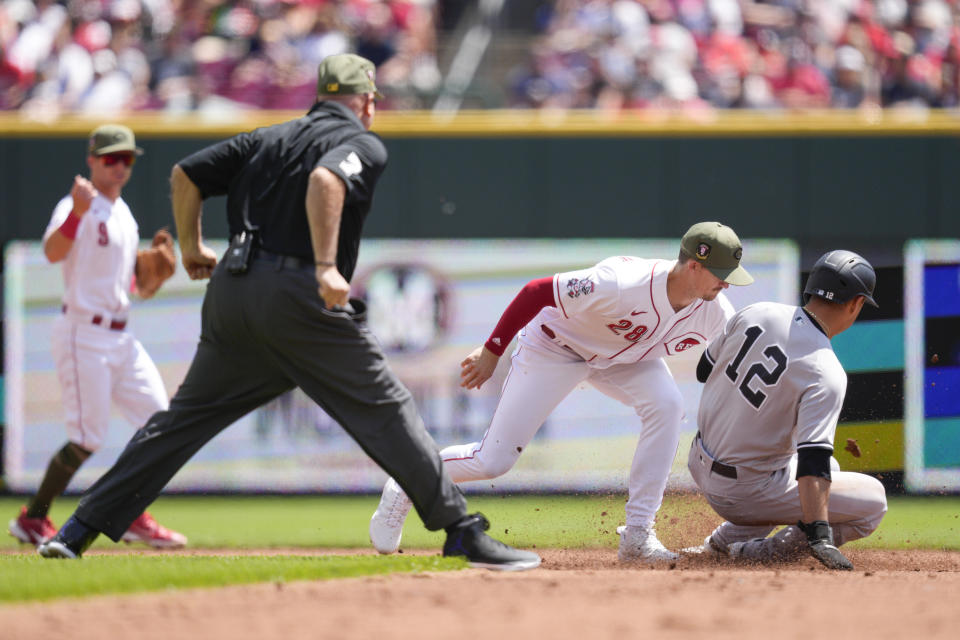 New York Yankees' Isiah Kiner-Falefa (12) is caught stealing second base by Cincinnati Reds second baseman Kevin Newman (28) in the third inning of a baseball game in Cincinnati, Sunday, May 21, 2023. (AP Photo/Jeff Dean)