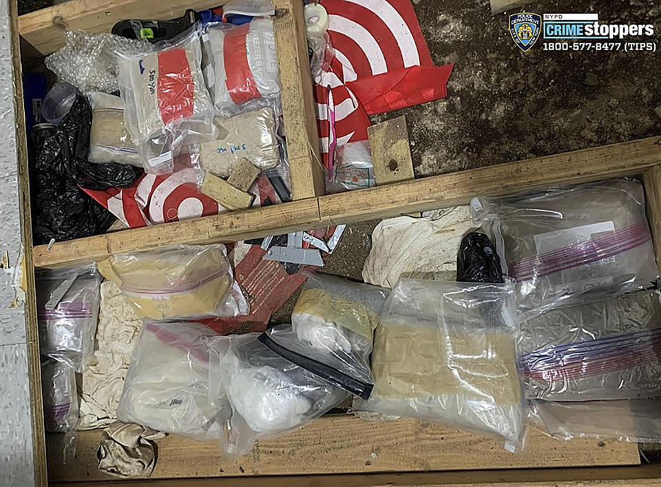 In this photo provided by the New York City Police Department, narcotics, including fentanyl, and drug paraphernalia lie stored in the floor of a day care center, Thursday, Sept. 21, 2023, in New York. Police say the owners of the New York City day care center where a toddler died and three others were sickened by opioid exposure the week before were hiding the bags of fentanyl concealed by plywood and tile flooring. (Courtesy NYPD via AP)