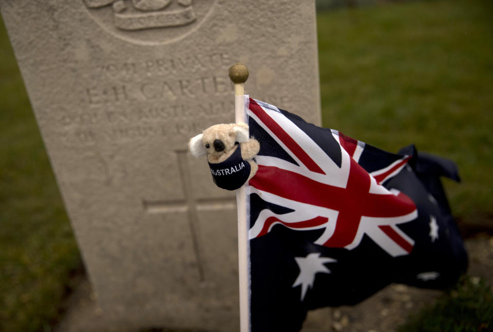 An Australian flag with a koala bear adorns a grave of a soldier at the World War I Australian National Memorial in Villers-Bretonneux, France, Saturday, Nov. 10, 2018. The memorial walls at the site bear the names of 11,000 missing Australian soldiers who died in France during World War I. (AP Photo/Francisco Seco)