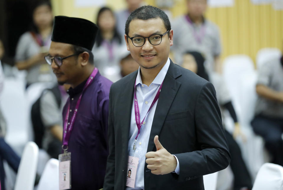 Saiful Bukhari Azlan, former aide to Malaysia reform icon, Anwar Ibrahim, thumbs up as he arrives for by-election nomination in Port Dickson, Malaysia, Saturday, Sept. 29, 2018. (AP Photo/Vincent Thian)