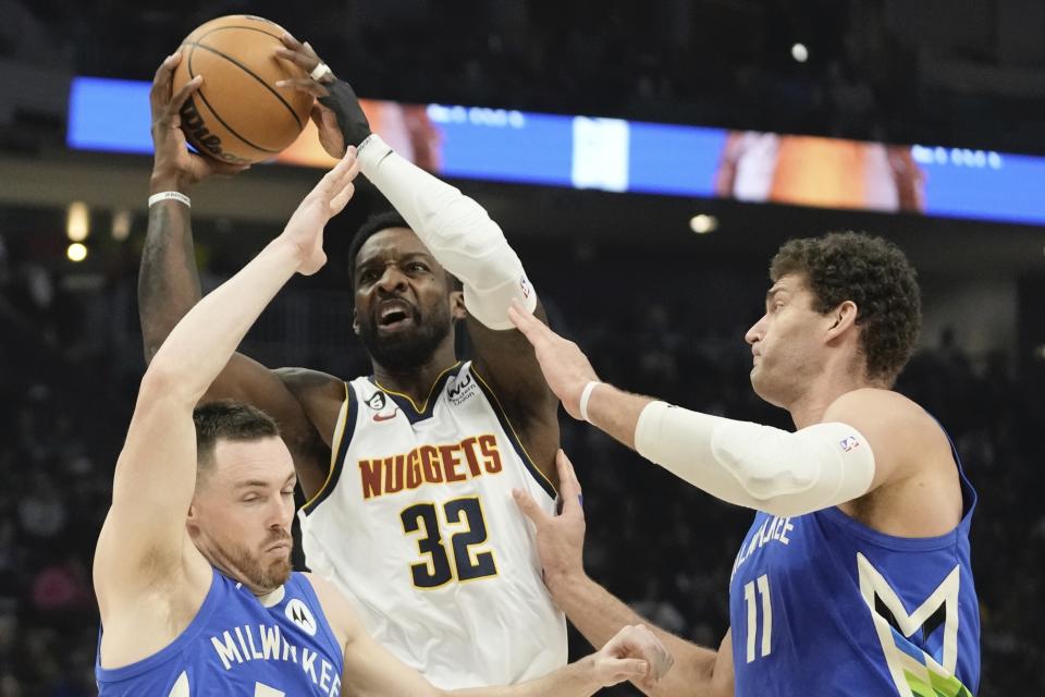 Denver Nuggets' Jeff Green is fouled by Milwaukee Bucks' Pat Connaughton during the first half of an NBA basketball game Wednesday, Jan. 25, 2023, in Milwaukee. (AP Photo/Morry Gash)