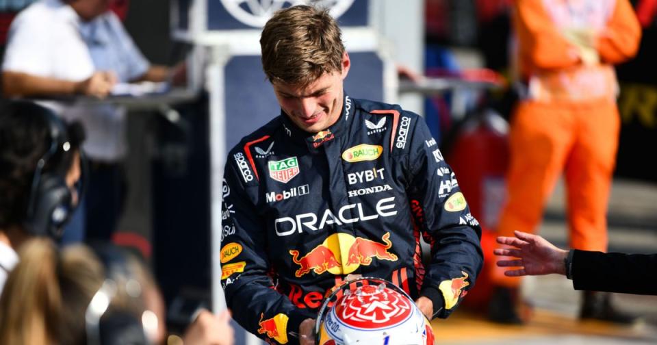 Red Bull driver Max Verstappen smiling as he puts his helmet down after another good session. Credit: Alamy