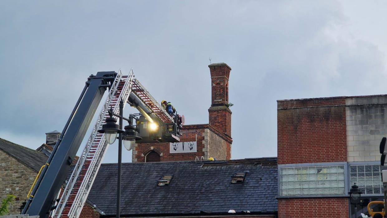 Image of fire fighters on a roof