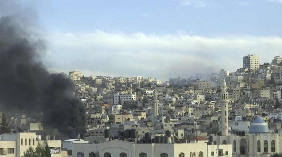 Smoke rises from buildings following Israeli raid in the occupied West Bank city of Jenin on Tuesday, March 7, 2023. Israeli military officials, speaking on condition of anonymity to discuss events still unfolding, said the army had entered Jenin to arrest suspects involved in the killing of two Israeli brothers in the northern West Bank town of Hawara last week. (AP Photo)