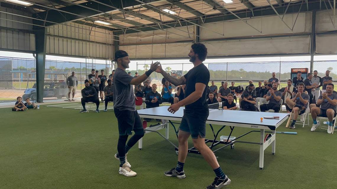 Miami Marlins utility player Garrett Hampson and left-handed relief pitcher Andrew Nardi shake hands after the team’s ping-pong championship on Sunday, March 26, 2023.