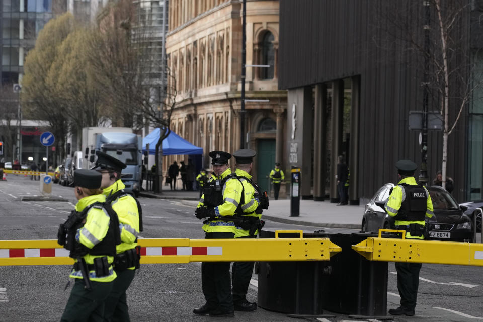 Police stand guard outside the hotel where President Joe Biden will stay in Belfast, Northern Ireland, Tuesday, April 11, 2023. President Biden is visiting Northern Ireland and Ireland to celebrate the 25th Anniversary of the Good Friday Agreement. (AP Photo/Christophe Ena)