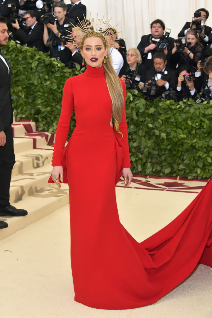 <p>Heard achieved a full look with a red Carolina Herrera gown and gorgeous gold headpiece. (Photo: Getty Images) </p>