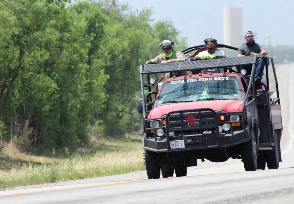 An ECCA truck returns mid-day Thursday to the Mesquite Heat staging area at the Taylor County Precinct 1 barn in View. U.S. Highway 277 is closed to regular traffic at its intersection with FM 1235 at View.