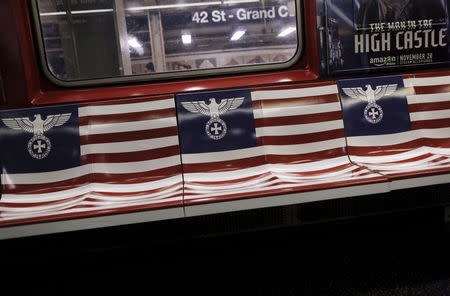 Seats wrapped with advertising for the Amazon series "The Man in the High Castle" are seen on a 42nd Street Shuttle subway train in the Manhattan borough of New York, November 24, 2015. New York City Mayor Bill de Blasio on Tuesday called on Amazon.com Inc to remove "irresponsible and offensive" subway advertisements for a new television show featuring Nazi-inspired imagery. The advertisements for "The Man in the High Castle" include a version of the American flag with a German eagle and iron cross in place of the stars, as well as a stylized flag inspired by imperial Japan. REUTERS/Brendan McDermid