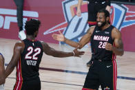 Miami Heat forward Jimmy Butler (22) and guard Andre Iguodala (28) celebrate their win over the Indiana Pacers in an NBA basketball first round playoff game, Saturday, Aug. 22, 2020, in Lake Buena Vista, Fla. (AP Photo/Ashley Landis, Pool)