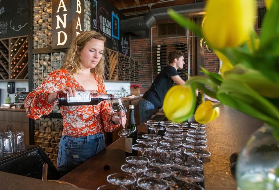 Laura Morris mixes a LaSalle’s La Mure drink on Wednesday, April 27, 2022, inside Ironhand Wine Bar in South Bend. 