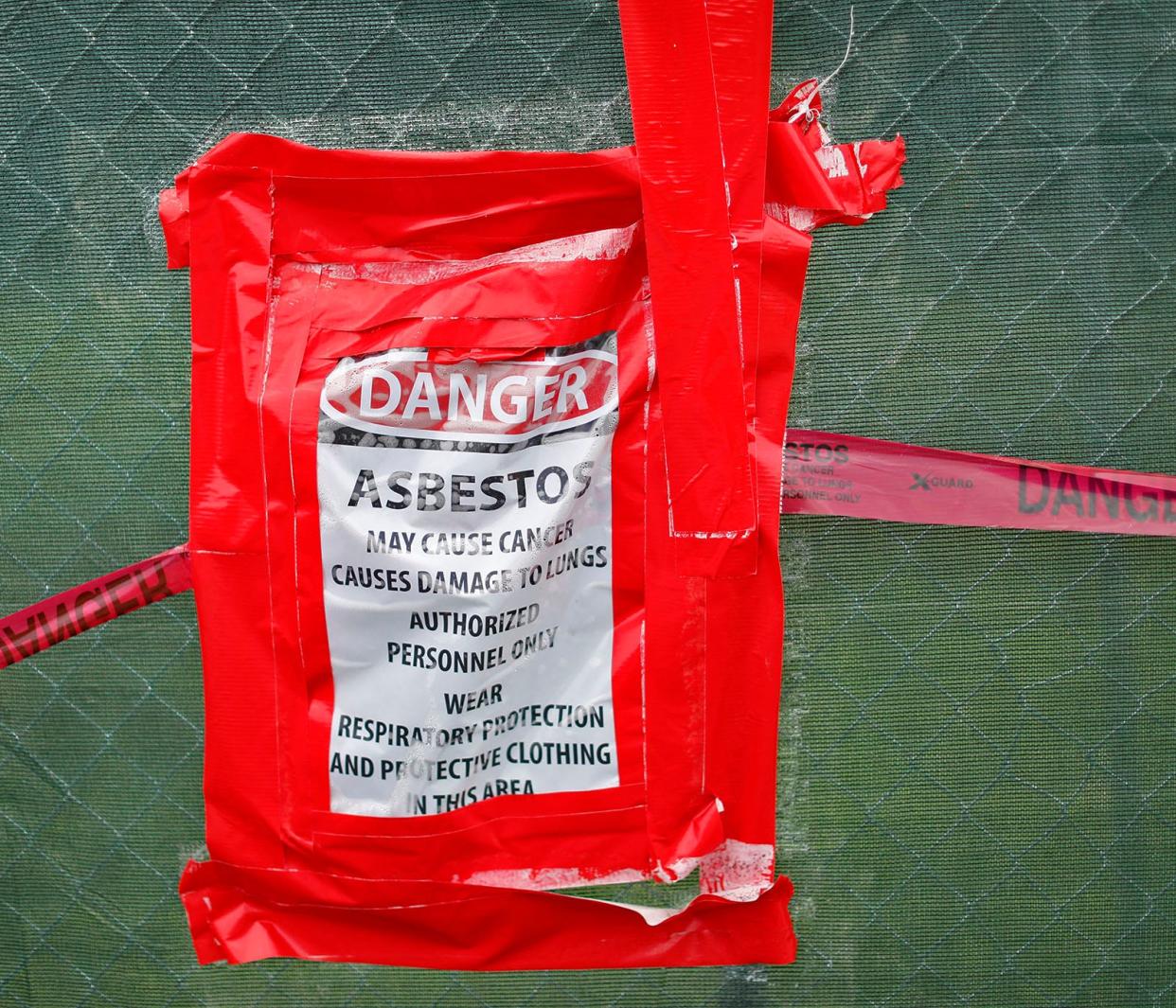 A sign at the future site of the Quincy Animal Shelter on Quarry Street warns of asbestos Tuesday, July 18, 2023.
