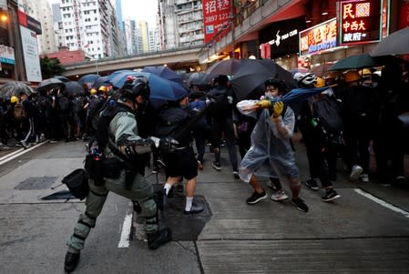 A riot police officer clashes with a protester during an anti-government rally in central Hong Kong