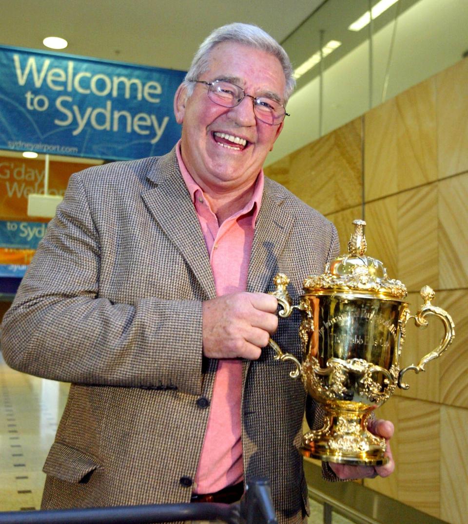 Millar, chairman of the IRB, arrives in Sydney with the Webb Ellis Trophy before the 2003 World Cup