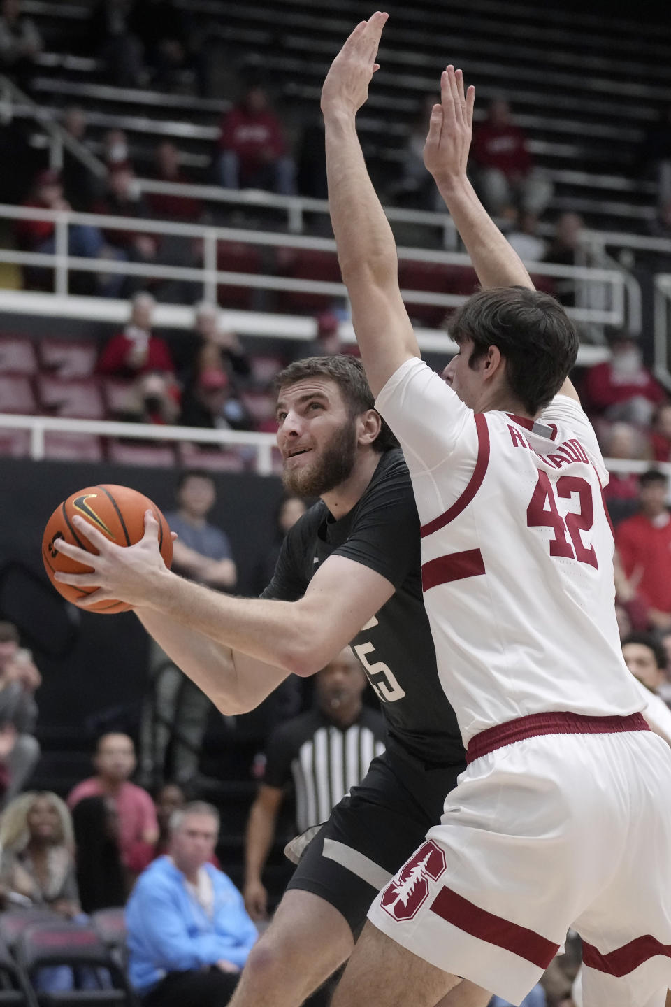 Washington State forward Oscar Cluff, left, drives to the basket against Stanford forward Maxime Raynaud (42) during the first half of an NCAA college basketball game in Stanford, Calif., Thursday, Jan. 18, 2024. (AP Photo/Jeff Chiu)