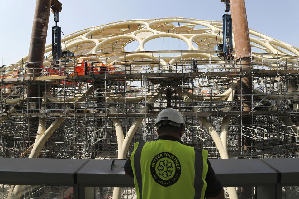 In this Oct. 8, 2019 photo, an employee of the Dubai Expo 2020 visits the Al Wasl Dome at the under construction site of the Expo 2020 in Dubai, United Arab Emirates. (AP Photo/Kamran Jebreili)