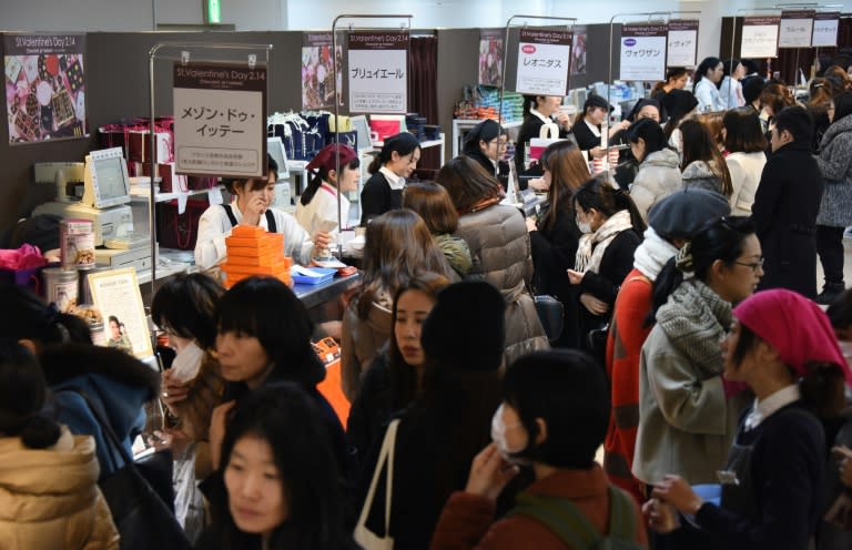 Women crowd around chocolate counters at a Toyko department store ahead of Valentine's Day