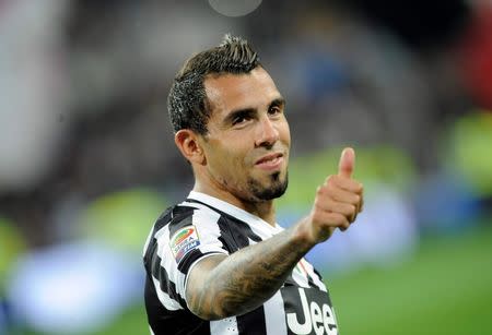 Juventus' Carlos Tevez celebrates after winning the Serie A championship at the end of their match against Atalanta at the Juventus stadium in Turin May 5, 2014. REUTERS/Giorgio Perottino/Files