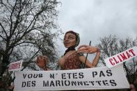 A puppet is seen behind a sign reading 'You are not a marionnette', during a rally against global warming, in Paris, On November 29, 2015