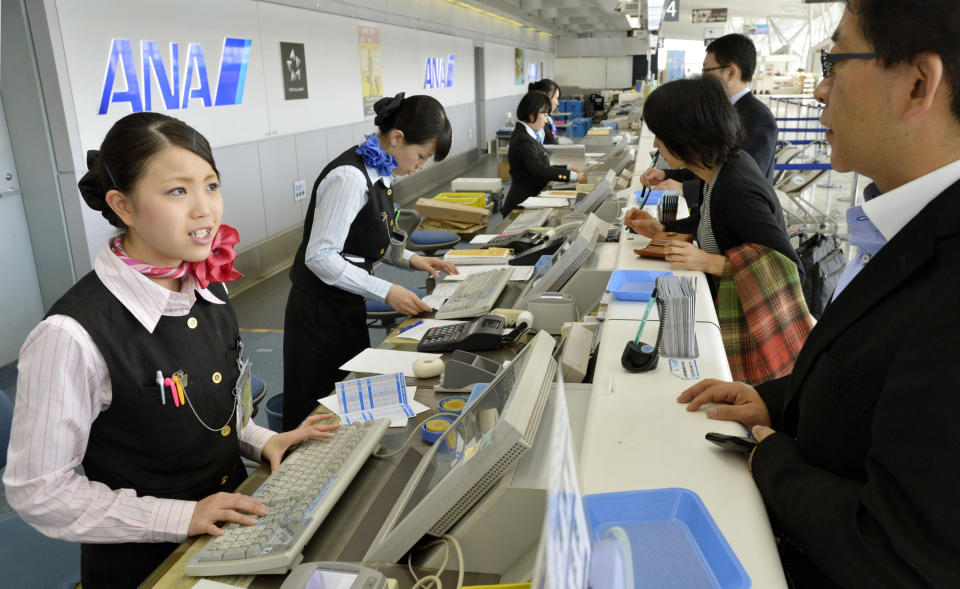 Employees deal with passengers at the counter at Sendai Airport in Sendai, northern Japan after flights in and out of the airport were canceled Tuesday, Oct. 30, 2012. The airport has been closed after an unexploded bomb believed to be from World War II was found during construction near a runway. (AP Photo/Kyodo News) JAPAN OUT, MANDATORY CREDIT, NO LICENSING IN CHINA, FRANCE, HONG KONG, JAPAN AND SOUTH KOREA